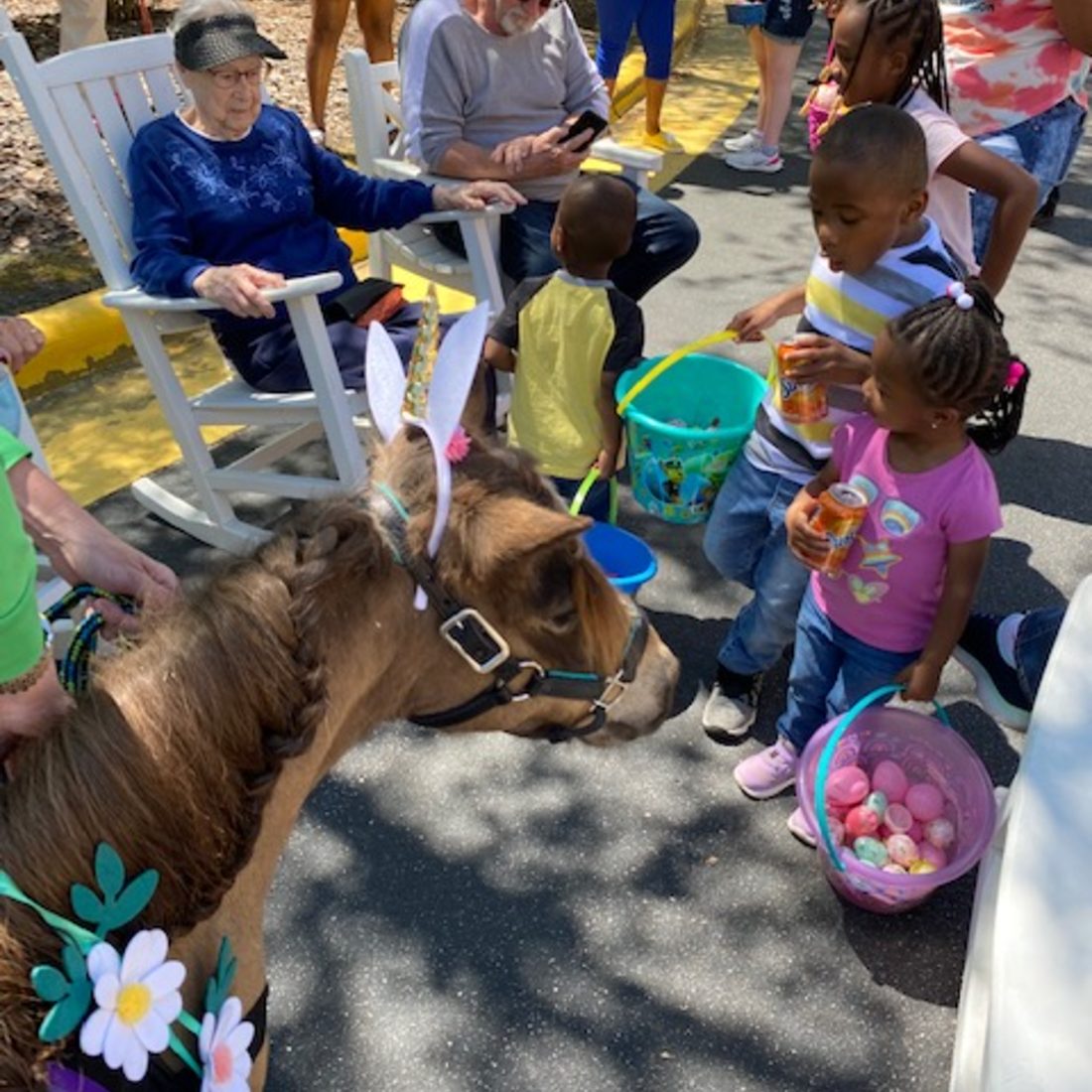 Children with Easter baskets meeting Mister Waffles